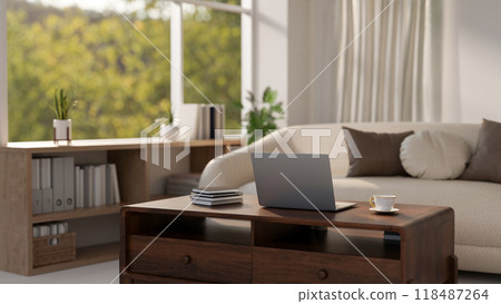 A laptop sits on a hardwood coffee table in a cozy, contemporary living room. A laptop sits on a hardwood coffee table in a cozy, contemporary living room. 118487264