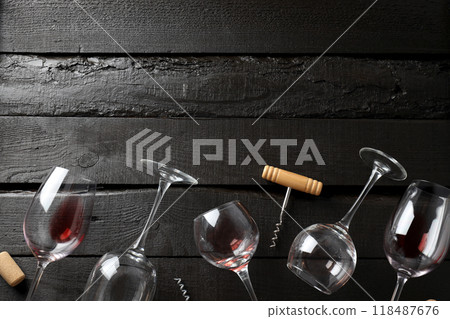 Glasses with wine and a corkscrew, on a dark background. Glasses with wine and a corkscrew, on a dark background. 118487676