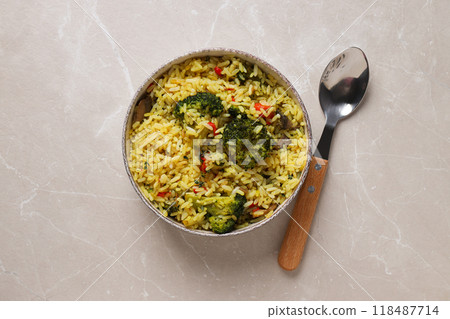 Pilaf in bowl and spoon on light background, top view Pilaf in bowl and spoon on light background, top view 118487714