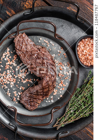 BBQ Grilled Machete or skirt beef meat steak in steel tray. Wooden background. Top view BBQ Grilled Machete or skirt beef meat steak in steel tray. Wooden background. Top view 118487767