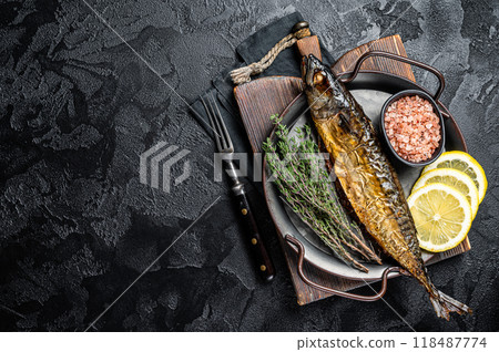 Baked Mackerel Scomber fish in steel tray with thyme and lemon. Black background. Top view. Copy space 118487774