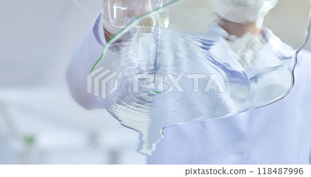 Researcher pour water cascades from a glass beaker, creating ripples in a shallow glass, symbolizing the delicate balance of scientific experimentation in a modern lab. 118487996