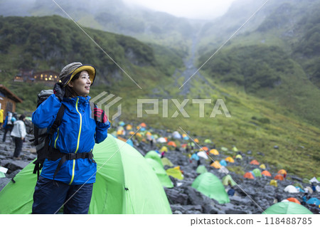A woman hiking in a tent 118488785
