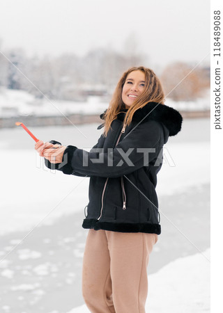 Young happy woman is smiling and holding a firework or sparkler in her hand Young happy woman is smiling and holding a firework or sparkler in her hand 118489088