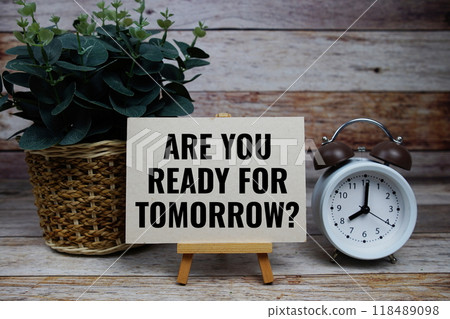 Are you ready for tomorrow? text on paper card with alarm clock on wooden background Are you ready for tomorrow? text on paper card with alarm clock on wooden background 118489098