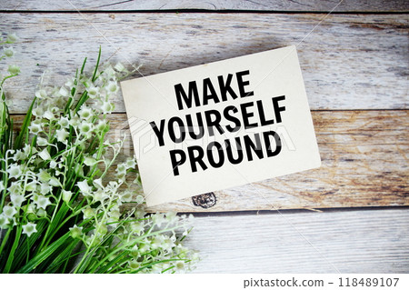 Make Yourself Pround text on paper card with flowers bouquet top view on wooden background 118489107