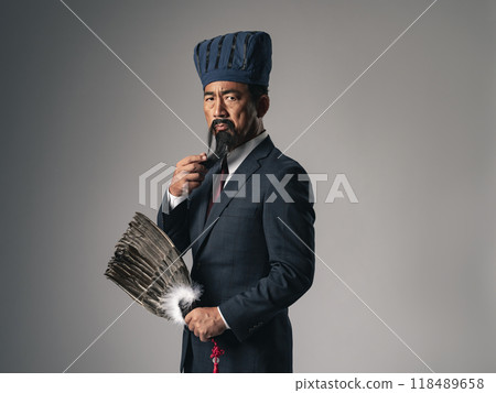 A scene of a historical Chinese military strategist, such as Zhuge Liang from the Romance of the Three Kingdoms, thinking while wearing a business suit 118489658