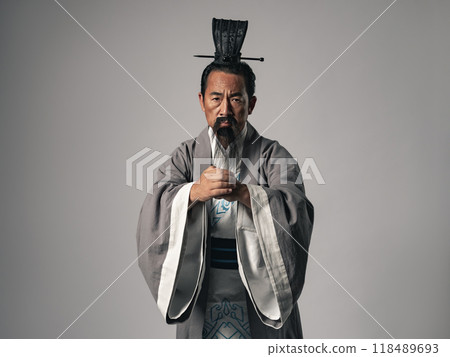 A scene of a great figure from Chinese history, such as one from the Romance of the Three Kingdoms, giving a greeting A scene of a great figure from Chinese history, such as one from the Romance of the Three Kingdoms, giving a greeting 118489693