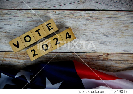Vote 2024, Presidential Election with USA American flag on wooden background Vote 2024, Presidential Election with USA American flag on wooden background 118490151