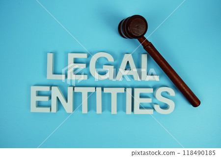 Legal Entities alphabet letters with wooden judge gavel on blue background 118490185