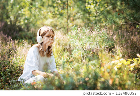 Girl listening to music with headphones. Girl listening to music with headphones. 118490352