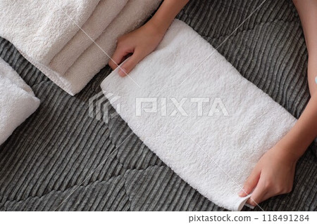 Elementary school students folding towels 118491284