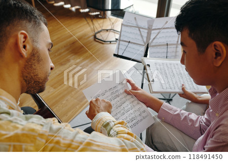 Reviewing Music Sheets Indoors For Practice Session Reviewing Music Sheets Indoors For Practice Session 118491450