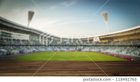 Stadium table background. Wooden table with blurred sports stadium background 118492768