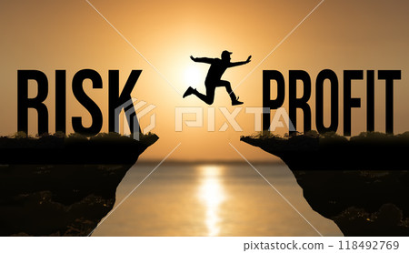 Risk and profit business concept. Man jumping at sunset. Business, development, success Risk and profit business concept. Man jumping at sunset. Business, development, success 118492769