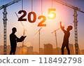 2025 year concept. Construction worker and crane on the backdrop of sunset and the numbers 2025 118492798