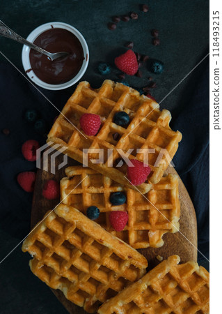 Belgian waffles on a dark background Belgian waffles on a dark background 118493215