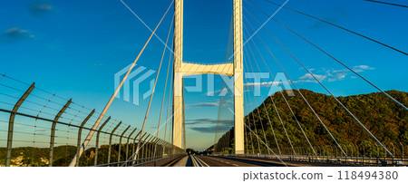 Panorama of sunrise over Megami Ohashi Bridge [Nagasaki City] 118494380