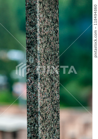 Close-Up of Granite Pillar with Natural Texture Against Soft Focus Background 118494860