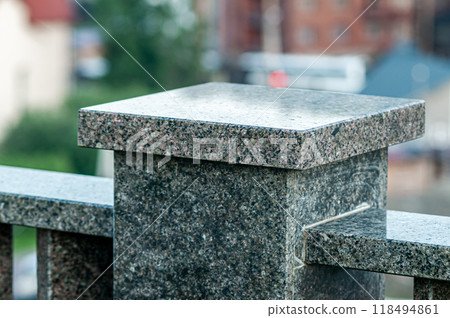 Close-Up of Granite Stone Pillar with Urban Background Close-Up of Granite Stone Pillar with Urban Background 118494861