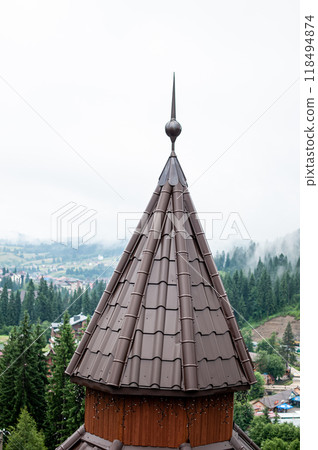 Majestic Spire Overlooking Misty Pine Forest with Rustic Village Landscape Majestic Spire Overlooking Misty Pine Forest with Rustic Village Landscape 118494874