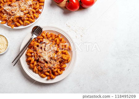Cavatappi pasta with tomato sauce and grated parmesan cheese 118495209