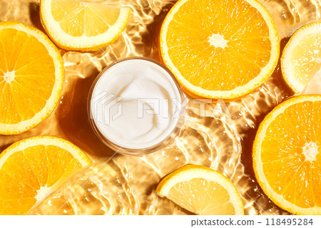 Cosmetic cream and orange citrus slices in water 118495284