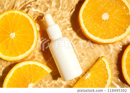 Serum bottle and orange citrus slices in water 118495302