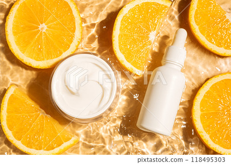 Cosmetic products in yellow water background with orange citrus 118495303