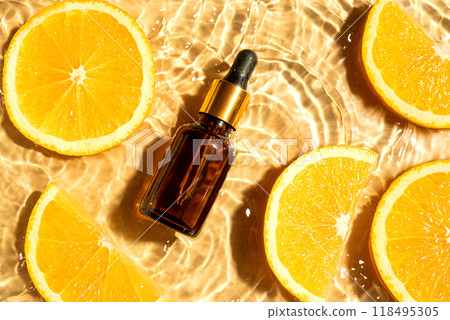 Face serum and orange citrus slices in water 118495305