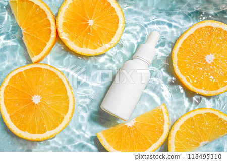 White serum bottle and oranges in water 118495310