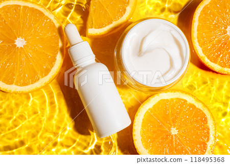 Cosmetic products and orange citrus slices in water 118495368
