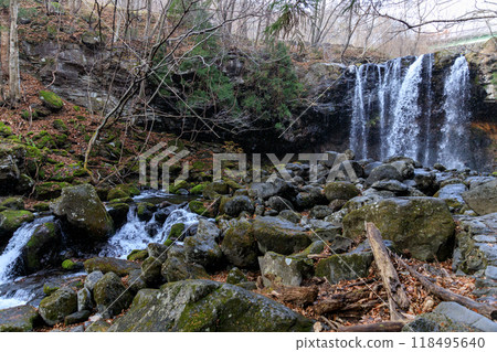 Falling snow and a beautiful waterfall Falling snow and a beautiful waterfall 118495640