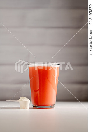 Collagen protein powder. Protein pink powder in a glass. Collagen protein powder. Protein pink powder in a glass. 118495879
