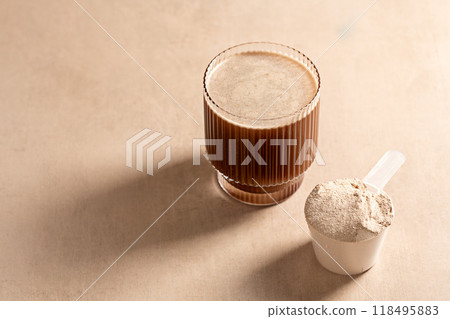 Chocolate protein powder in a measuring scoop. Nutrition and food supplement Chocolate protein powder in a measuring scoop. Nutrition and food supplement 118495883