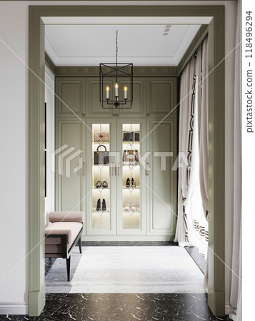 Chic walk-in closet with green cabinetry, illuminated shelves, and a cozy bench. Modern lighting and elegant design create a refined and stylish dressing area. 118496294