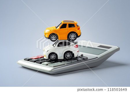 Car toy stacking on calculator on blue background Car toy stacking on calculator on blue background 118501649