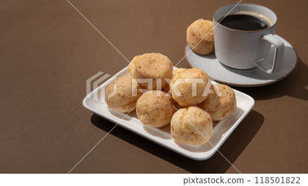 Cup of coffee with Brazilian cheese breads on the brown background Cup of coffee with Brazilian cheese breads on the brown background 118501822