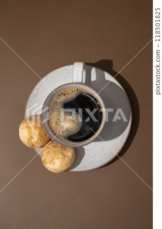 Cup of coffee with Brazilian cheese breads on the brown background Cup of coffee with Brazilian cheese breads on the brown background 118501825