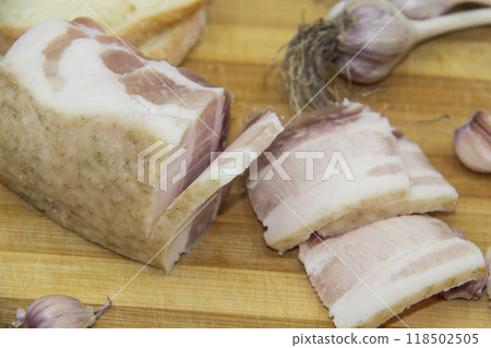 Very tasty pieces of salo. Raw ukrainian bacon or salo on wooden board. Ukrainian traditional food concept. 118502505