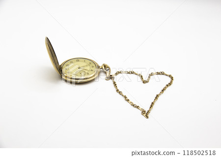 Vintage golden old pocket watch on white background. The chain lies in the form of a heart. Vintage golden old pocket watch on white background. The chain lies in the form of a heart. 118502518