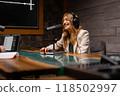 A woman is equipped in a studio to record a podcast professionally with modern audio technology 118502997