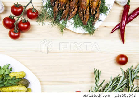 Composition with crayfish on the white plate, pepper, tomatoes, garlic, dill, parsley, pickled cucumbers, rosemary. Cooking food background with free space for text. Top view with copy space 118503542