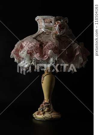 Lace fabric desk Lamp shade table with Rococo baroque style on black background. Lace fabric desk Lamp shade table with Rococo baroque style on black background. 118504163