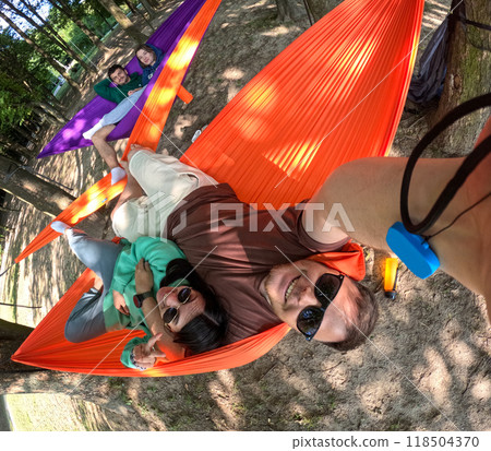 Relaxing in Colorful Hammocks in the Forest Relaxing in Colorful Hammocks in the Forest 118504370