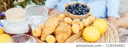 Picnic in the chamomile field. A large field of flowering daisies. The concept of outdoor recreation. 118504463