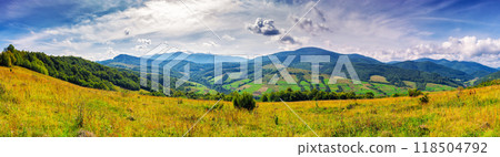 panorama of rural landscape in carpathian mountains in autumn. sunny day. grassy field and rolling hills. countryside scenery of ukraine. village in the distant valley panorama of rural landscape in carpathian mountains in autumn. sunny day. grassy field and rolling hills. countryside scenery of ukraine. village in the distant valley 118504792