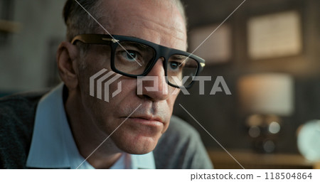 Close up of senior psychotherapist in glasses communicating and listening to patient 118504864
