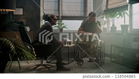 Male soldier in wheelchair shakes hands with psychotherapist 118504865