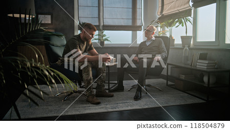 Depressed military man with PTSD talks to specialist on counseling session 118504879